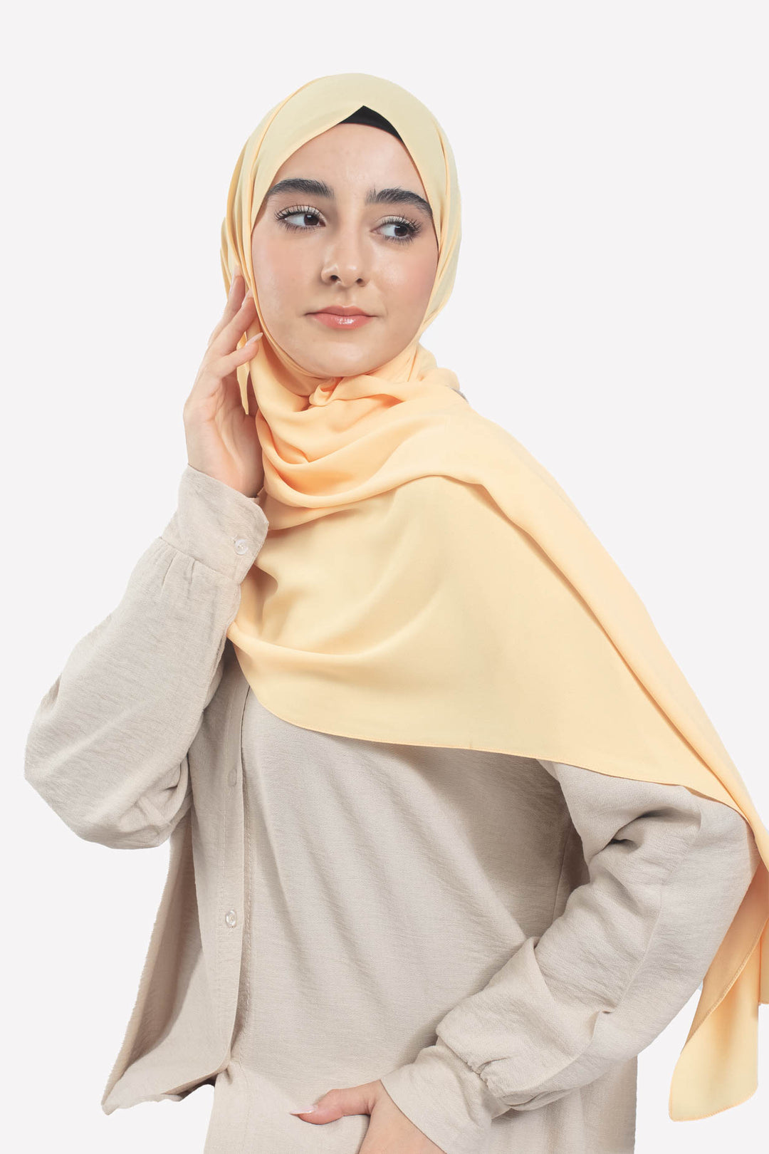 Woman wearing a light yellow hijab 